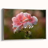 Framed botanical wall art featuring a geranium design on canvas, showcasing vibrant colors and intricate details, displayed with a sleek silver frame for an elegant touch.