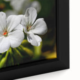 Close-up of a framed botanical wall art piece showcasing vibrant geranium flowers in rich hues of pink and green, perfect for home decor enhancement.