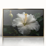 Framed wall art featuring a vibrant botanical hibiscus design in shades of pink and green, set in a sleek gold frame, perfect for modern home decor.