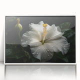 Framed wall art featuring a vibrant botanical hibiscus design, showcasing intricate floral details in shades of pink and green, set against a white background.