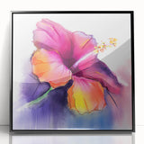 Framed wall art featuring a botanical hibiscus design in vibrant colors, set in a sleek black frame, ideal for home decor and floral-themed spaces.