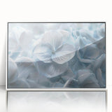 Framed botanical wall art featuring a vibrant hydrangea design in shades of blue and white, elegantly displayed with a sleek white frame, perfect for home decor.