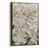 Framed canvas wall art showcasing a botanical hydrangea design with a black frame, elegantly displayed from a side view, perfect for home decor.