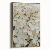 Framed canvas wall art showcasing a botanical hydrangea design with gold accents, elegantly displayed at an angle to highlight its vibrant colors and textures. Perfect for enhancing home decor with a touch of nature-inspired elegance.