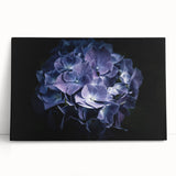 Stretched canvas wall art showcasing a vibrant blue hydrangea botanical design, elegantly leaning against a neutral wall, perfect for home decor.