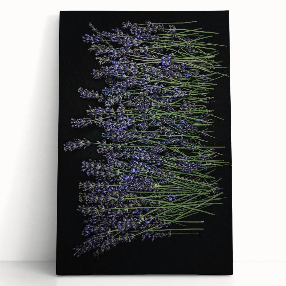 Botanical wall art featuring a serene lavender design on stretched canvas, elegantly leaning against a light-colored wall, enhancing home decor with a calming touch.