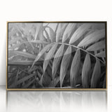 Framed acrylic wall art showcasing a botanical leaves design with vibrant green foliage and elegant gold accents, perfect for modern home decor.