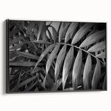 Framed canvas wall art featuring a botanical design of vibrant flowers and leaves, displayed against a sleek black background, ideal for home decor.