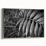 Framed canvas wall art showcasing a botanical leaves design with silver accents, set against a neutral background, ideal for modern home decor.