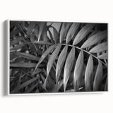 Framed wall art featuring a botanical design of vibrant flowers and leaves on a white background, showcasing a modern aesthetic ideal for home decor.