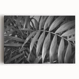 Stretched canvas wall art featuring a botanical design with vibrant flowers and leaves, ideal for home decor. Perfect for adding a touch of nature to any room.