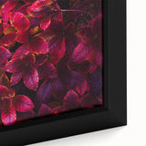 Framed canvas artwork showcasing a vibrant botanical design with colorful flowers and leaves, ideal for home decor. Perfect for enhancing living spaces with nature-inspired aesthetics.
