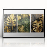 Framed wall art featuring a botanical leaves design in vibrant greens and soft browns, set against a sleek black frame, perfect for modern decor.