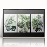 Framed wall art featuring a botanical design with vibrant flowers and leaves, set in an elegant silver frame, ideal for home decor and nature enthusiasts.