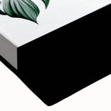 Close-up of a botanical leaves wall art design on stretched canvas, showcasing vibrant green hues and intricate leaf patterns, perfect for nature-inspired decor.