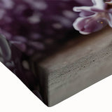 Close-up of a vibrant lilac botanical wall art design on stretched canvas, showcasing intricate floral details and rich purple hues, perfect for home decor.