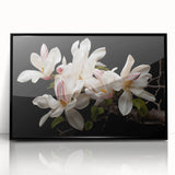 Framed wall art featuring a botanical magnolia design in vibrant colors, set against a sleek black background, perfect for modern home decor.