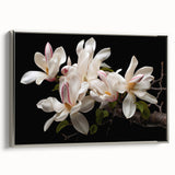 Framed wall art showcasing a botanical magnolia design in soft pastel colors, featuring a silver frame, elegantly displayed from a side view. Ideal for home decor.