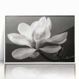 Framed botanical wall art featuring a magnolia design, displayed in a white frame against a neutral background, ideal for home decor enhancement.