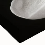 Close-up of a stretched canvas featuring a botanical magnolia design, showcasing vibrant pink and white flowers against a soft blue background, perfect for home decor.