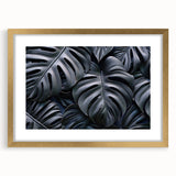 Botanical monstera wall art collection framed in gold with a matte finish, showcasing vibrant green leaves and intricate details, perfect for stylish home decor.