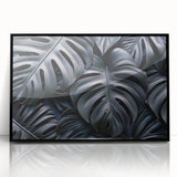 Framed wall art featuring a botanical monstera design, showcasing vibrant green leaves on a sleek black background, ideal for modern home decor.