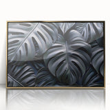 Framed wall art featuring a vibrant botanical monstera design, showcasing lush green leaves and a modern gold-acrylic frame, perfect for home decor.