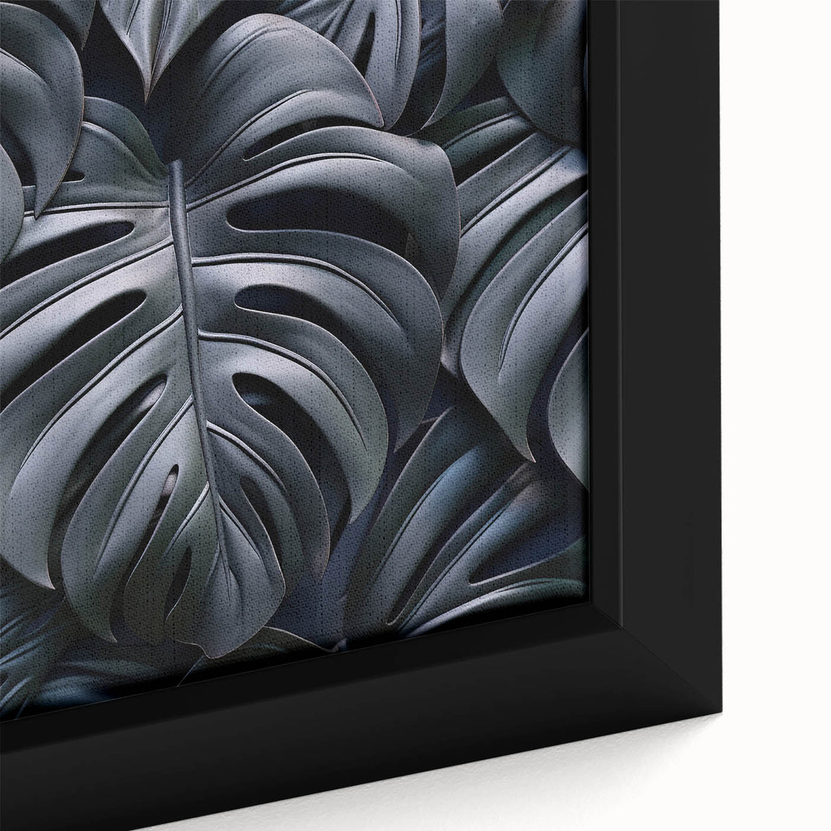 Close-up view of a vibrant framed canvas print showcasing a botanical Monstera design with lush green leaves, perfect for home decor and plant enthusiasts.