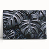 Vibrant botanical wall art featuring a lush monstera leaf design on stretched canvas, ideal for home decor, showcasing rich green tones against a neutral background.