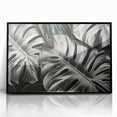 Framed acrylic wall art showcasing a vibrant Monstera plant design on a black background, perfect for modern decor. Ideal for botanical enthusiasts looking to enhance their home aesthetic.