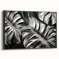 Framed wall art featuring a botanical monstera design on canvas, showcasing vibrant green leaves against a black background, ideal for modern home decor.