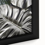 Close-up view of a framed botanical wall art piece featuring a vibrant Monstera plant design, showcasing rich green tones and intricate leaf details, ideal for home decor.