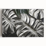 Botanical wall art featuring a vibrant monstera leaf design on stretched canvas, showcasing rich greens and detailed textures, perfect for enhancing home decor.