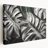 Stretched canvas wall art featuring a vibrant botanical monstera design, showcasing lush green leaves against a neutral background, perfect for home decor.