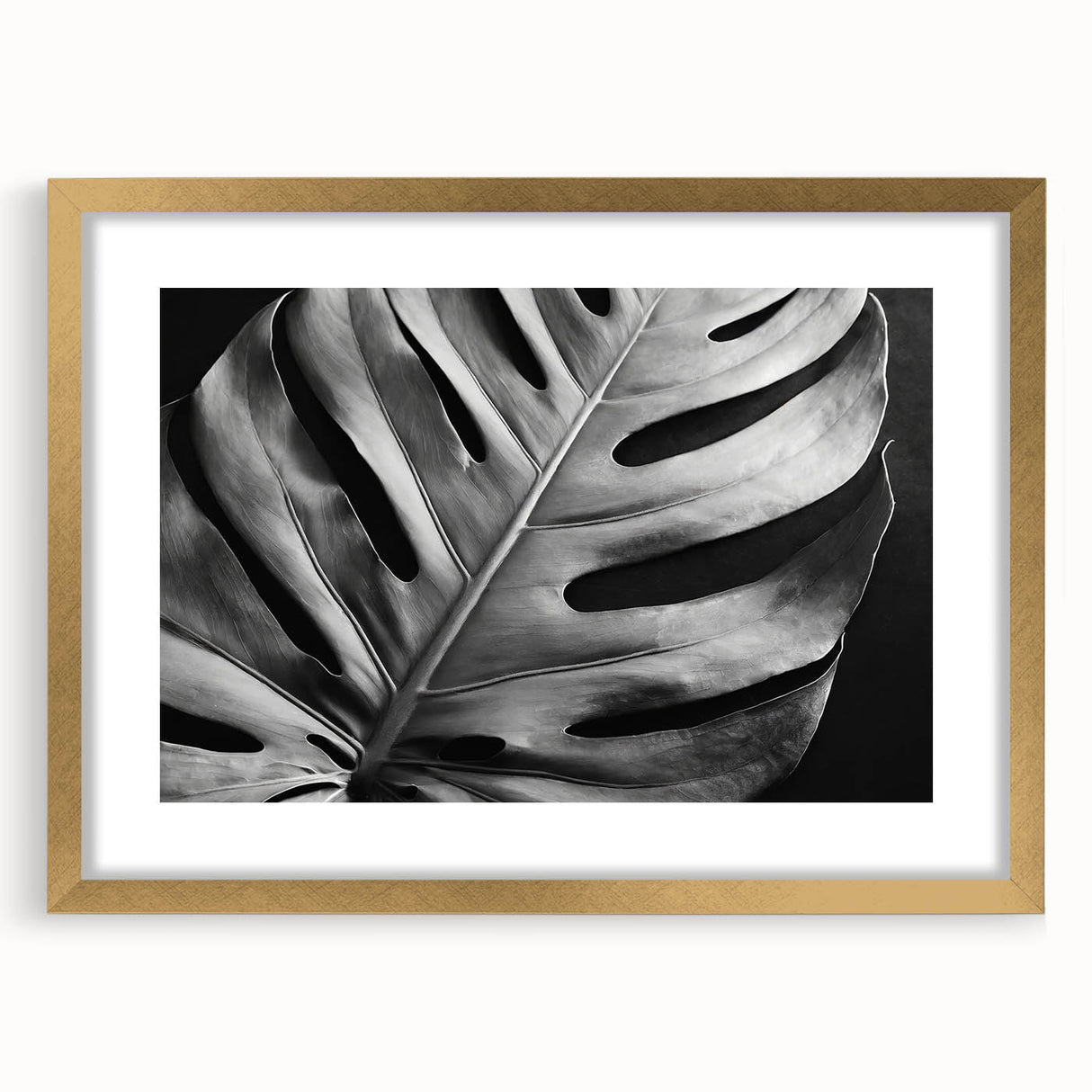 Framed botanical wall art featuring a Monstera design, elegantly displayed with a gold frame and mat, perfect for modern home decor and nature enthusiasts.