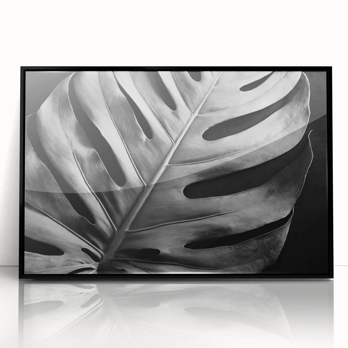 Framed wall art featuring a botanical monstera design in vibrant green and black, displayed in an acrylic frame, perfect for modern home decor.