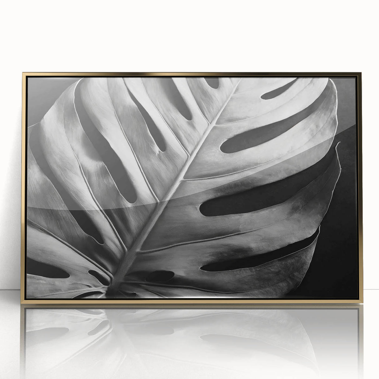 Framed botanical wall art featuring a Monstera leaf design with a gold acrylic front, ideal for modern home decor. Perfect for adding a touch of nature.