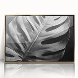 Framed botanical wall art featuring a Monstera leaf design with a gold acrylic front, ideal for modern home decor. Perfect for adding a touch of nature.