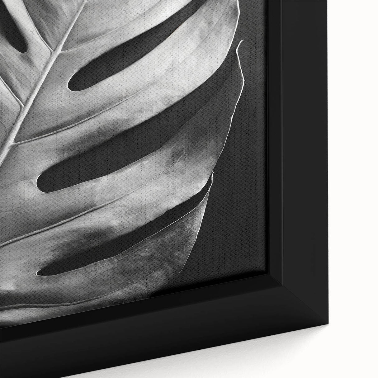Close-up of a framed botanical wall art piece showcasing a Monstera leaf design in vibrant green hues, perfect for adding a touch of nature to home decor.