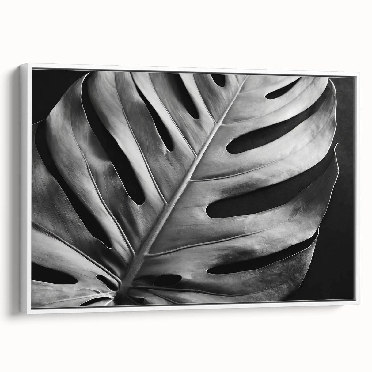 Framed wall art featuring a botanical design of a Monstera plant, showcasing vibrant green leaves against a white background, perfect for home decor.