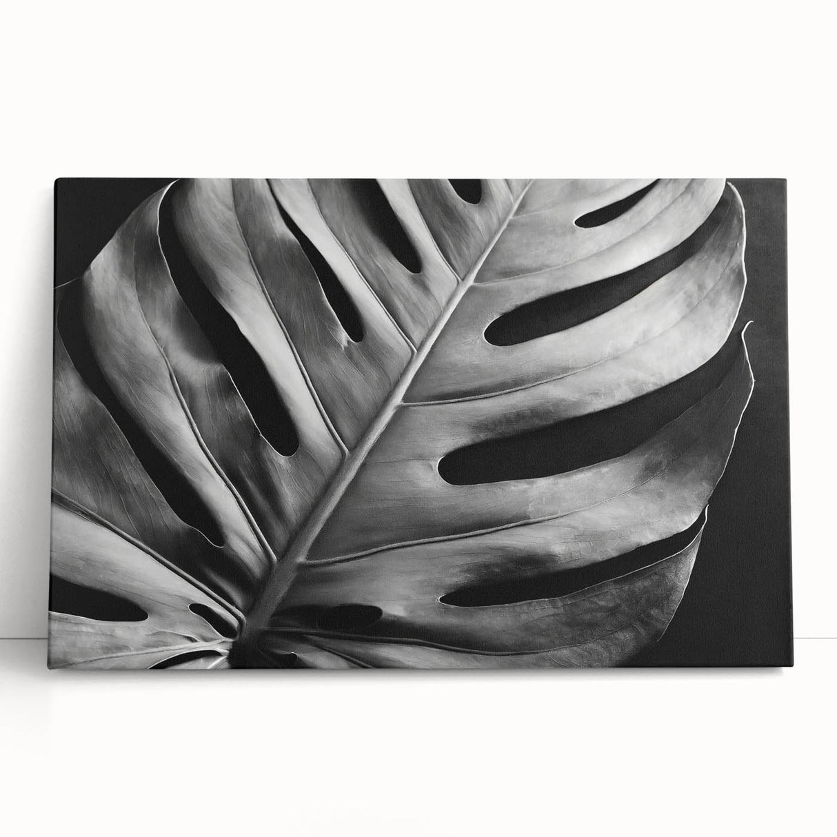 Botanical wall art featuring a vibrant Monstera plant design on stretched canvas, elegantly leaning against a neutral background, perfect for home decor.