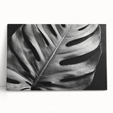 Botanical wall art featuring a vibrant Monstera plant design on stretched canvas, elegantly leaning against a neutral background, perfect for home decor.