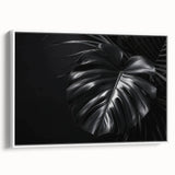 Framed wall art featuring a botanical design of a Monstera plant, set against a white background, showcasing lush green leaves for vibrant home decor. Ideal for nature-inspired interiors.