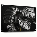 A side view of a vibrant botanical wall art collection featuring a Monstera design, displayed in a sleek acrylic glass frame with decorative pins, perfect for modern decor.