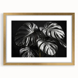 Framed botanical wall art featuring a Monstera design in vibrant greens and gold accents, showcasing elegant floral details and a sophisticated matte finish.
