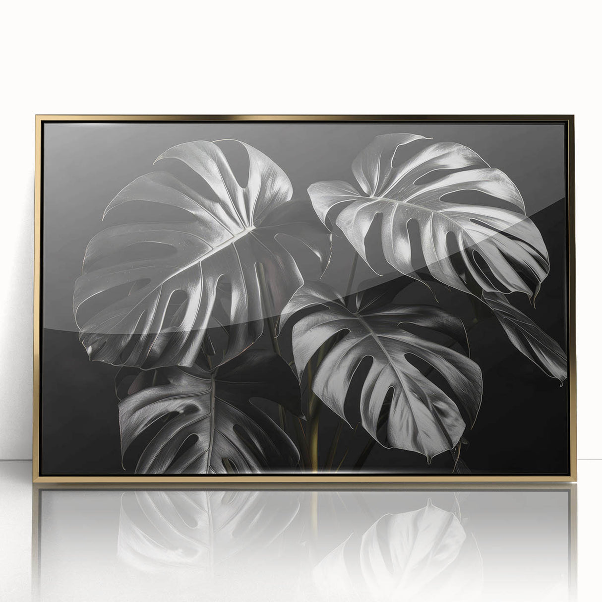 Framed botanical wall art featuring a Monstera plant design with a gold acrylic front; perfect for adding a touch of nature-inspired elegance to home decor.