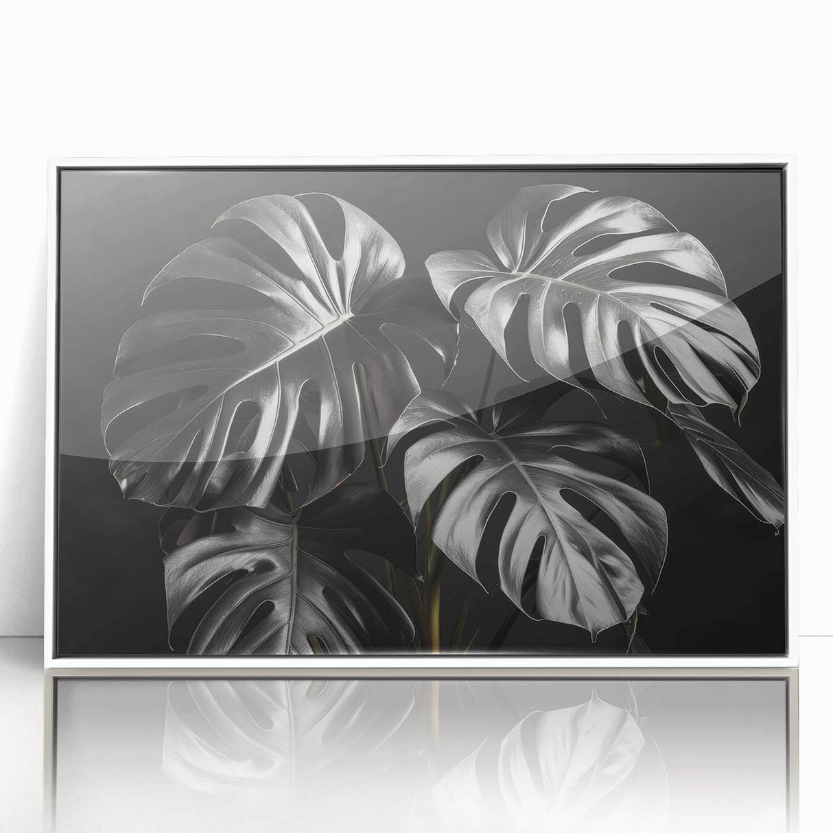 Framed wall art featuring a botanical design of a Monstera plant, displayed with a white frame and acrylic front, perfect for modern home decor.