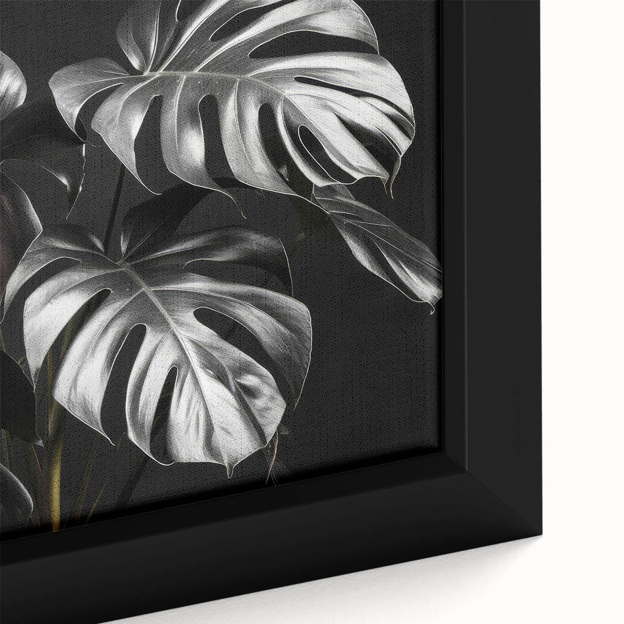 Close-up of a framed canvas showcasing vibrant monstera leaves in a botanical design, perfect for adding a tropical touch to any wall decor.