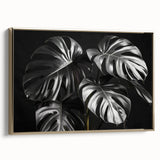 Framed wall art featuring a botanical Monstera design in gold, showcasing lush green leaves on a canvas. Ideal for modern home decor, adding an elegant touch to any room.