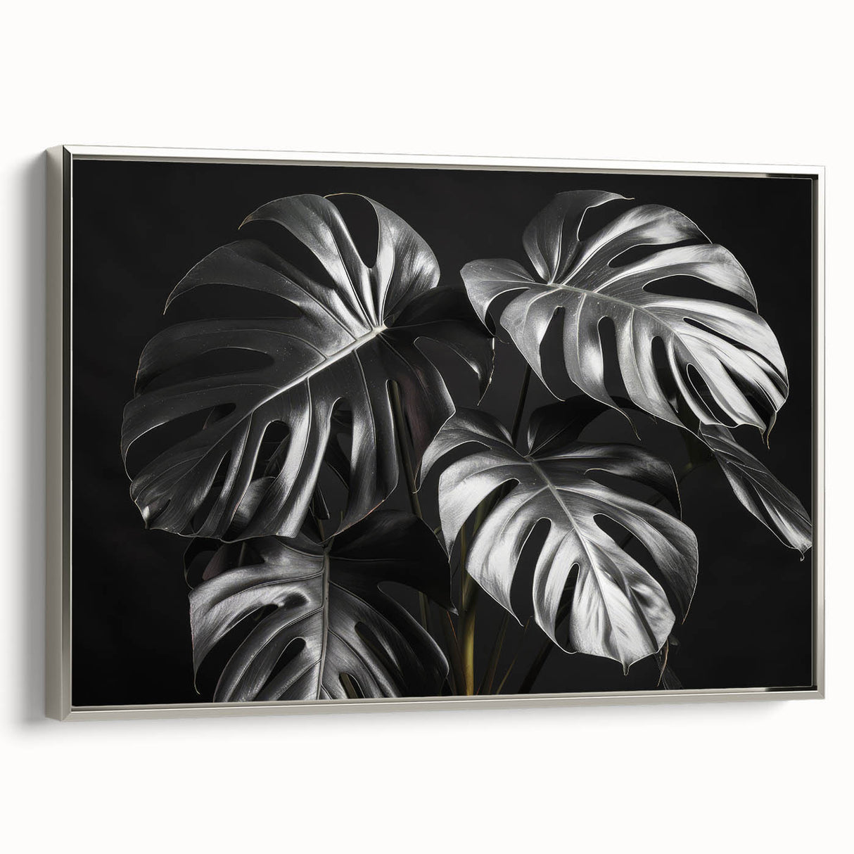 Framed wall art featuring a botanical Monstera design with vibrant green leaves against a silver background, showcasing contemporary decor for home or office.